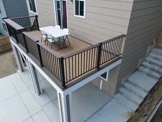 Elevated deck with concrete below and black railings