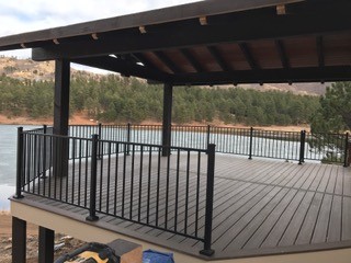 Covered deck pergola structure with railing