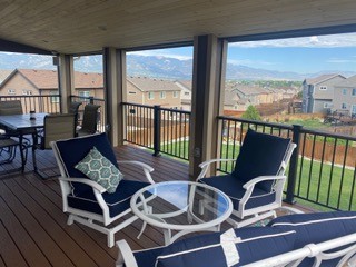 Covered deck seating area with mountain view